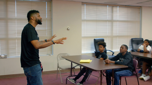 Von Johnson talks with participants in the Broken Men Foundation Youth Academy. He says he wants to give them the benefits of guidance he didn’t receive as a young man growing up in public housing communities.